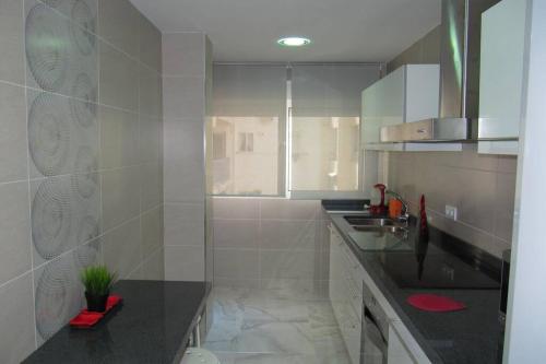 a kitchen with a sink and a counter top at piso con estilo cerca de la playa in Cullera
