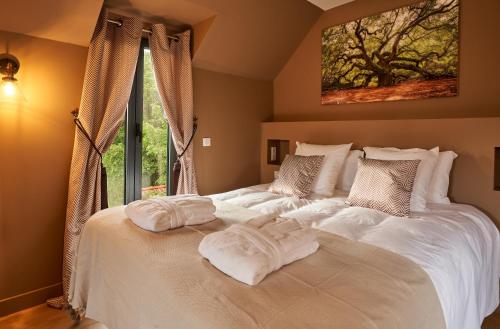 a bedroom with a large bed with two towels on it at LA VILLA AUBIN belle demeure avec vue sur Paris in Montmorency