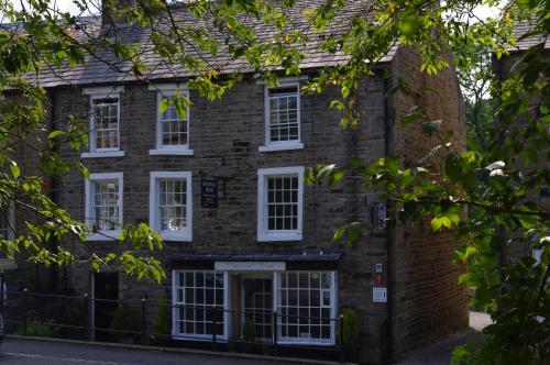 an old brick house with white windows at Brunswick House in Middleton in Teesdale