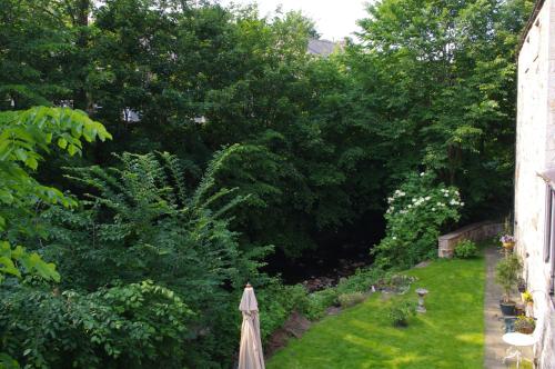 a garden with an umbrella in the grass at Brunswick House in Middleton in Teesdale