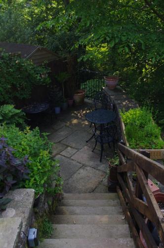 a patio with a table and chairs and plants at Brunswick House in Middleton in Teesdale