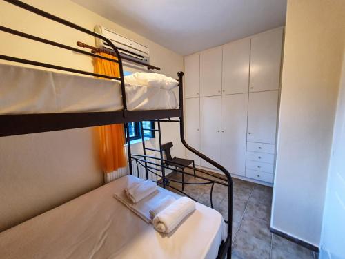 a small room with two bunk beds in it at Frigano 3 in Stoupa