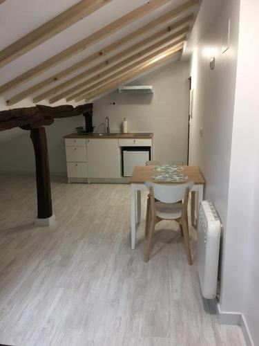 a room with a table and a kitchen with a counter at Castro Sun And Beach in Castro-Urdiales