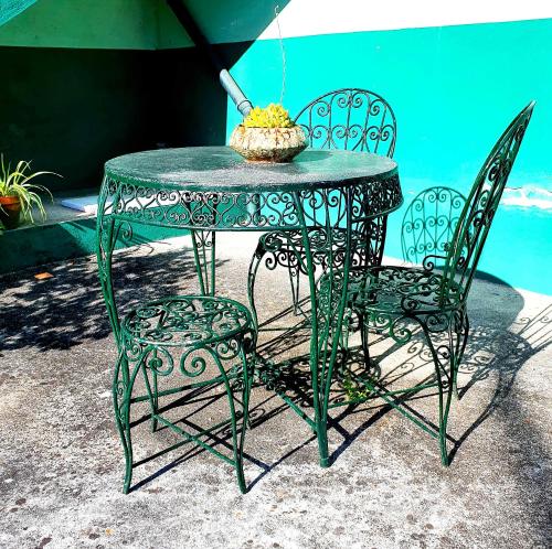 a table topped with a green chair next to a pool of water at Residencia LIS B&B in Porto