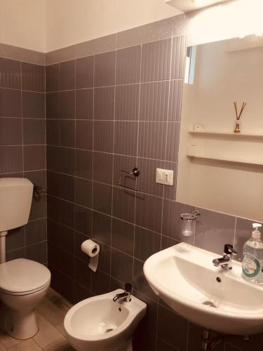 a bathroom with a toilet and a sink at All My Home in Villa San Giovanni
