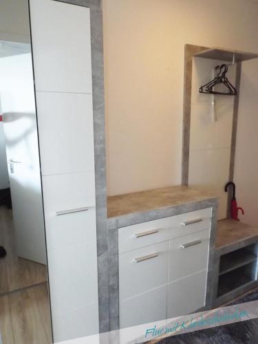 a closet with white cabinets and a mirror at Fewo Nationalpark Schwarzwald in Freudenstadt