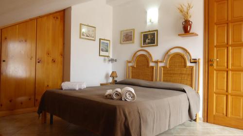 ein Schlafzimmer mit einem Bett mit zwei Paar Schuhen darauf in der Unterkunft Appartamento panoramico Santa Domenica in Santa Domenica