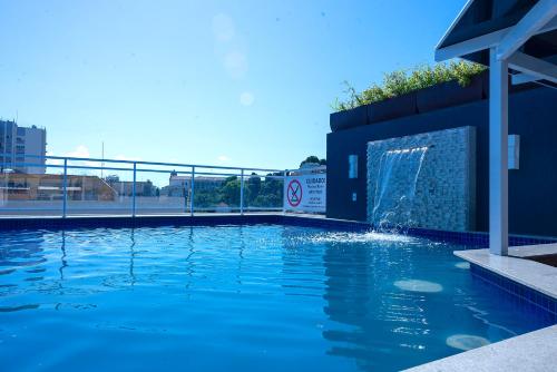 a swimming pool with a water fountain at Casa Nova Hotel in Rio de Janeiro