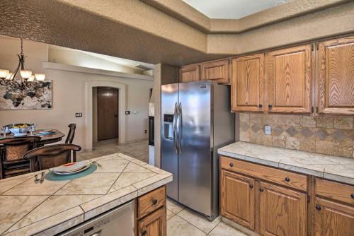 a kitchen with wooden cabinets and a stainless steel refrigerator at Heated Pool, Spa and Mtn Views Lake Havasu Home! in Lake Havasu City
