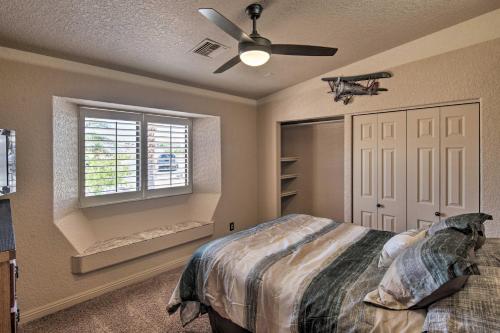 a bedroom with a bed and a ceiling fan at Heated Pool, Spa and Mtn Views Lake Havasu Home! in Lake Havasu City