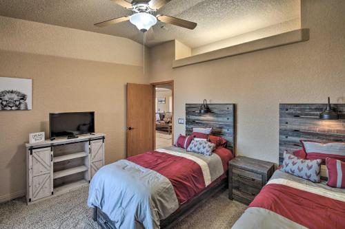 a bedroom with two beds and a flat screen tv at Heated Pool, Spa and Mtn Views Lake Havasu Home! in Lake Havasu City