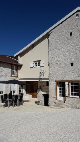 a large white building with chairs in front of it at Chez Madgi et Jean-Mi in Froncles