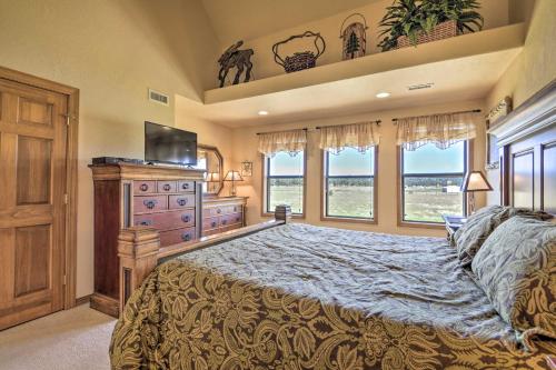 a bedroom with a bed and a dresser and windows at Hike and Fish Pagosa Springs Townhome with View! in Pagosa Springs