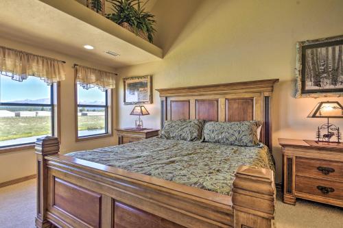 a bedroom with a large bed and two windows at Hike and Fish Pagosa Springs Townhome with View! in Pagosa Springs