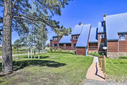 a house with a tree in front of it at Hike and Fish Pagosa Springs Townhome with View! in Pagosa Springs