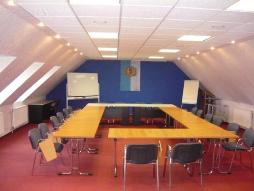a large conference room with a long table and chairs at Patyi Étterem és Hotel in Bögöte
