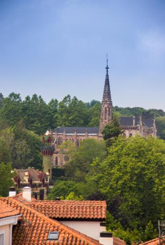 a view of a town with buildings and trees at Pasaje San Jorge in Comillas