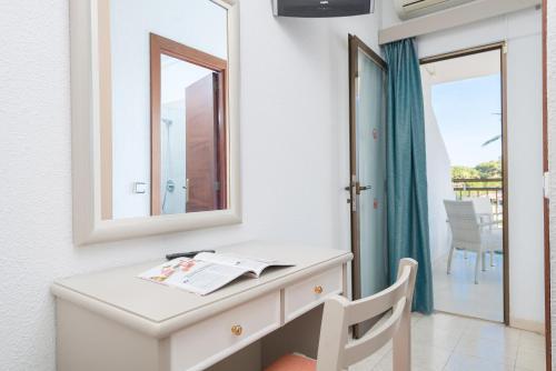a room with a wooden table and a window at Hotel Moré in Alcudia
