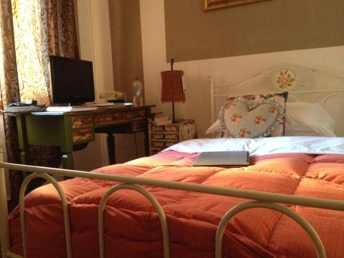 a bedroom with a bed with a laptop on it at Hotel Mignon in Trieste