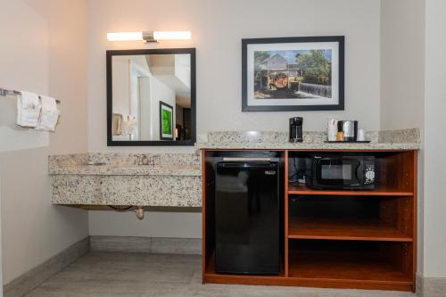 a kitchen with a sink and a mirror at Twin Mountain Inn & Suites in Pigeon Forge