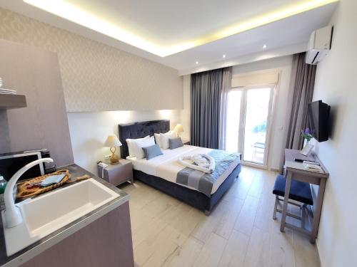 a hotel room with a bed and a sink and a tub at Deluxe Dina in Skala Potamias