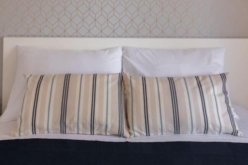 a bed with two pillows and a headboard at Apartments Agneza Tucepi in Tučepi