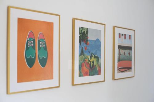 three framed pictures hanging on a wall at Apartments Agneza Tucepi in Tučepi