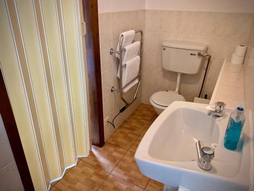 a bathroom with a sink and a toilet at Manchester Stay Hotel - Free Parking in Manchester