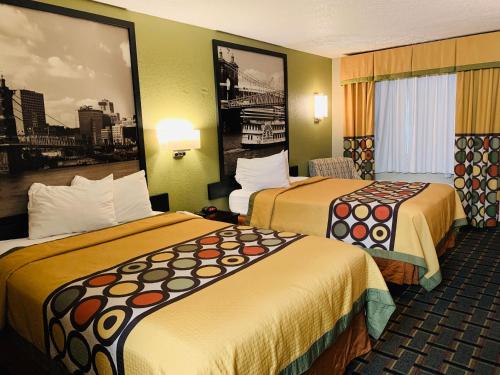 a hotel room with two beds in a room at Super 8 by Wyndham Cincinnati-Springdale OH in Springdale