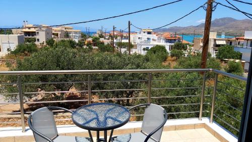 a table and chairs on a balcony with a view at Nikko's apartments Elafonisos in Elafonisos