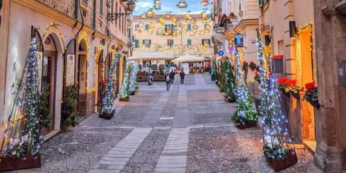 a city street with christmas decorations on the buildings at Alghero Old Town Apartment in Alghero