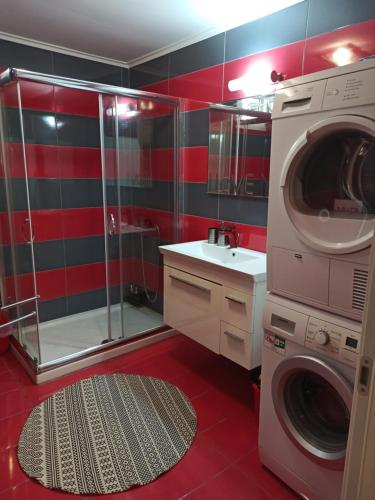 a bathroom with a washing machine and a sink at casa al mare in Kavála