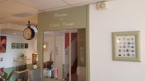 a store with a clock on the side of a building at Hôtel Trianon Tours in Tours