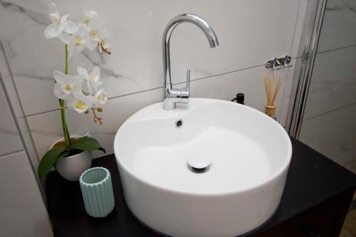 a white sink with a faucet in a bathroom at Apartmani Rustica in Drasnice