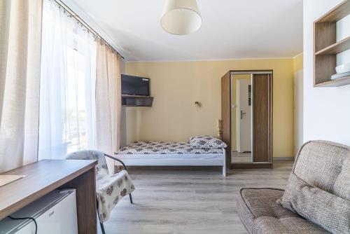 a living room with a bed and a window at Pokoje Iga in Władysławowo