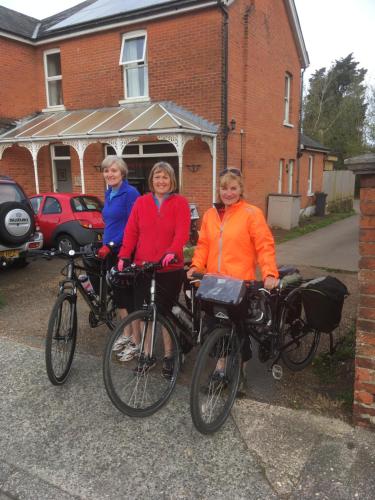 three women posing with their bikes in front of a house at Old Church House in Newport