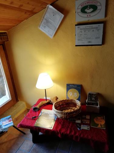 a room with a table with a lamp on top of it at Rota d'Amont in Stroppo
