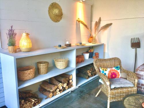 a shelf with baskets and a chair in a room at Attalos Suites Hotel in Bergama