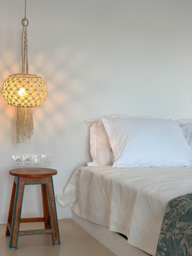 a bedroom with a bed with a table and a lamp at Almyriki in Mylopotas