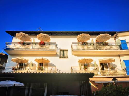 a building with umbrellas on the balconies at Albergo Al Pescatore in Brenzone sul Garda
