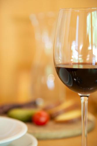 a glass of red wine sitting on a table at B & B Apartments Ortlerblick in Sluderno