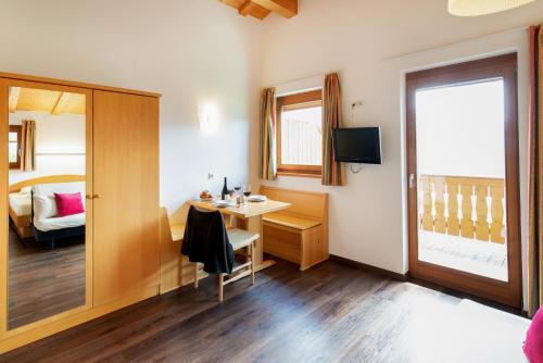 a small room with a desk and a window at B & B Apartments Ortlerblick in Sluderno