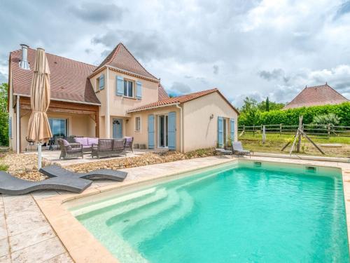 a swimming pool in front of a house at Quaint Villa in Aquitaine with Swimming Pool in Saint-Alvère