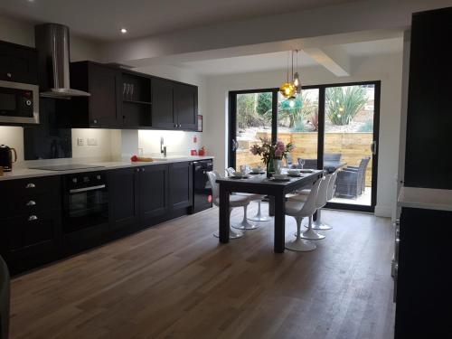 a kitchen with a table with chairs and a dining room at Abbey Field - Cyanacottages in Whitby