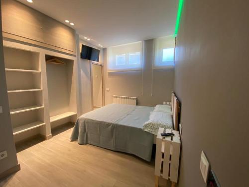 ein Schlafzimmer mit einem Bett und einem TV in der Unterkunft MIRASIERRA in Navarredonda de Gredos