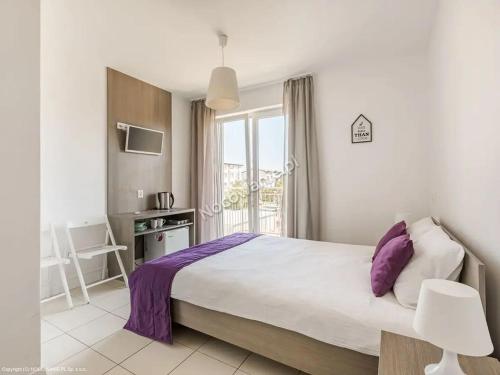 a bedroom with a large bed and a window at Villa Cicha in Karwia
