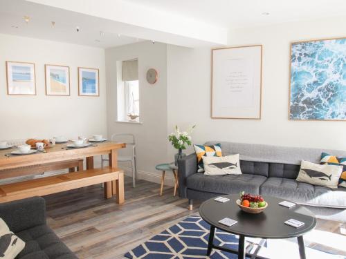 a living room with a couch and a table at Swanage Driftwood in Swanage