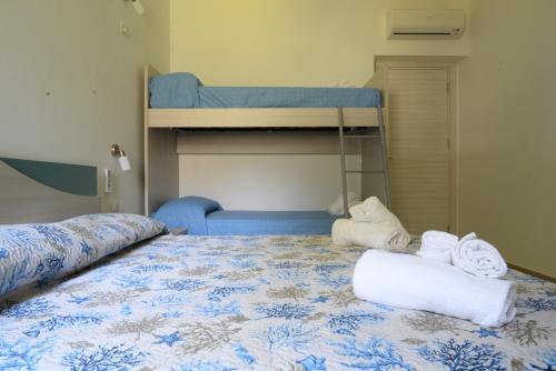 a bedroom with two bunk beds and towels on a bed at Villa Giovanni in Palinuro