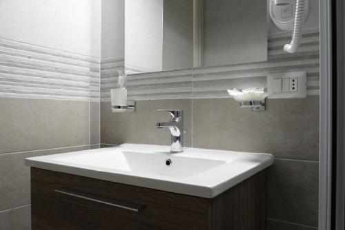a bathroom with a white sink and a mirror at Villa Giovanni in Palinuro