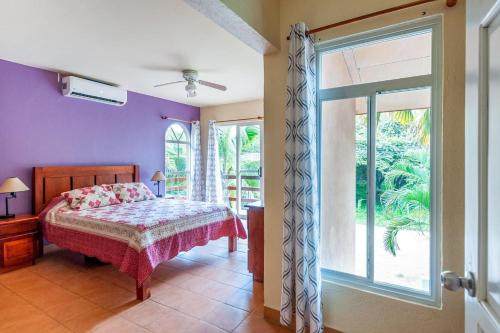 a bedroom with a bed and a large window at Nicely Priced Duplex in Surfside with Private Pool and AC in Every Room in Potrero